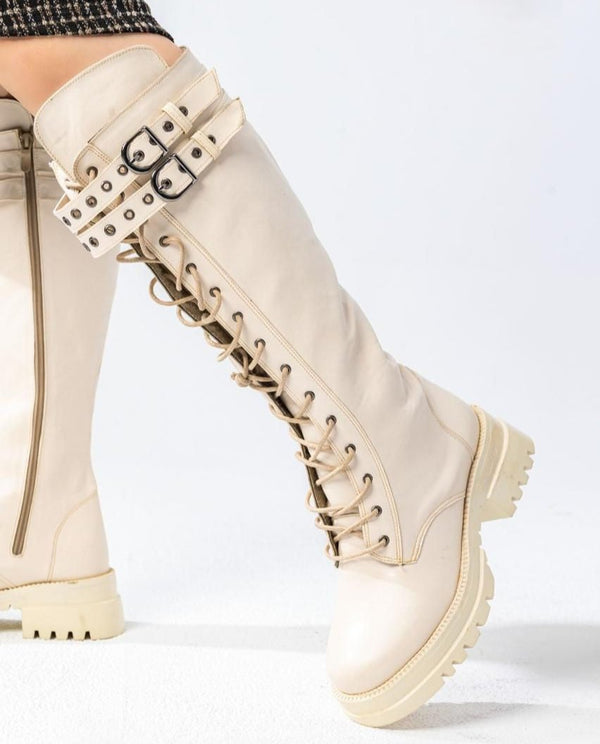 knee-high combat boots have a lace-up front, chunky sole, and two buckle straps B-37